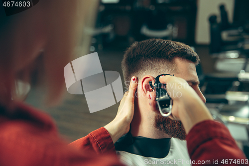 Image of Client during beard shaving in barber shop