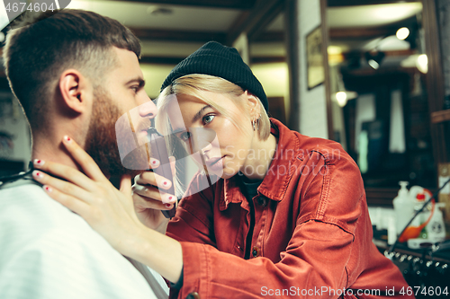 Image of Client during beard shaving in barber shop