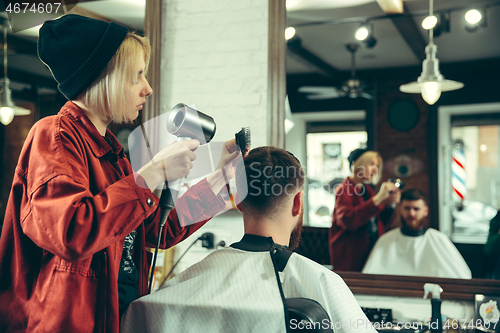 Image of Client during beard shaving in barber shop