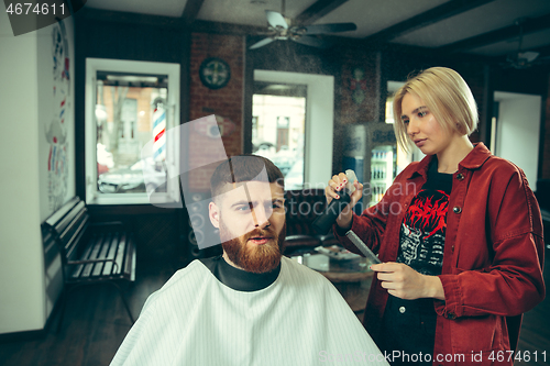 Image of Client during beard shaving in barber shop