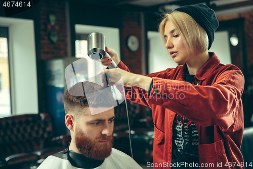 Image of Client during beard shaving in barber shop