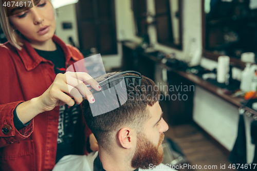 Image of Client during beard shaving in barber shop