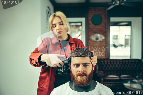 Image of Client during beard shaving in barber shop