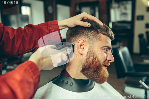 Image of Client during beard shaving in barber shop