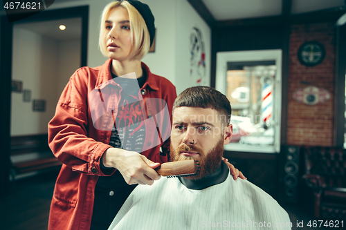 Image of Client during beard shaving in barber shop