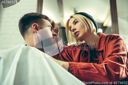 Image of Client during beard shaving in barber shop