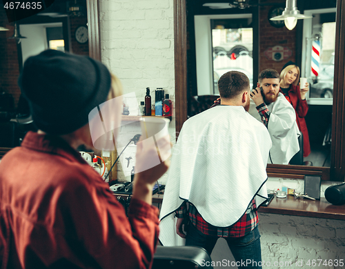 Image of Client during beard shaving in barber shop