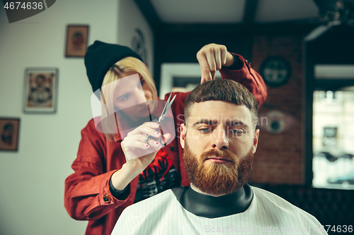 Image of Client during beard shaving in barber shop