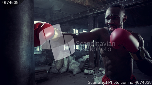 Image of Hand of boxer over black background. Strength, attack and motion concept