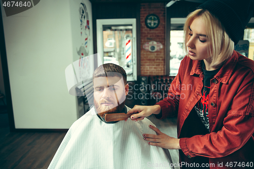 Image of Client during beard shaving in barber shop