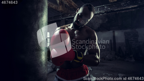 Image of Hand of boxer over black background. Strength, attack and motion concept