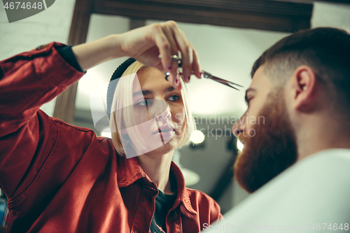 Image of Client during beard shaving in barber shop