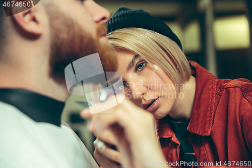 Image of Client during beard shaving in barber shop