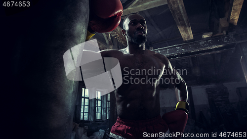 Image of Hand of boxer over black background. Strength, attack and motion concept