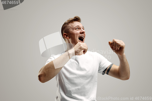 Image of Winning success man happy ecstatic celebrating being a winner. Dynamic energetic image of male model