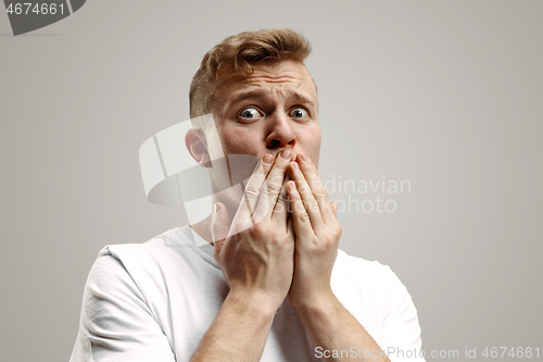 Image of Portrait of the scared man on gray