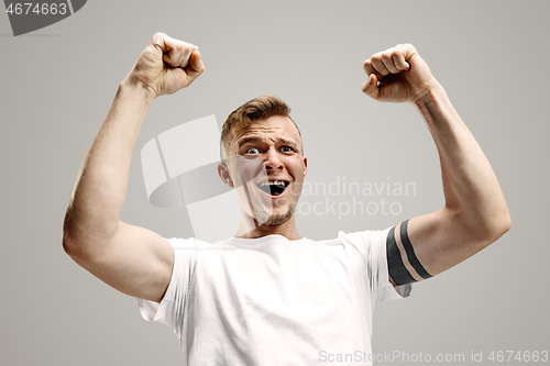 Image of Winning success man happy ecstatic celebrating being a winner. Dynamic energetic image of male model