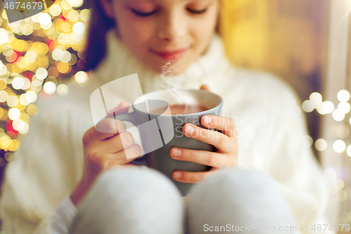 Image of close up of girl with hot chocolate on christmas