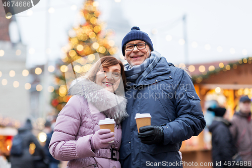 Image of senior couple with coffee at christmas market