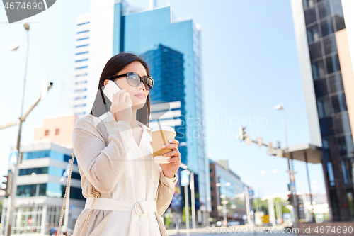 Image of asian woman calling on smartphone in city