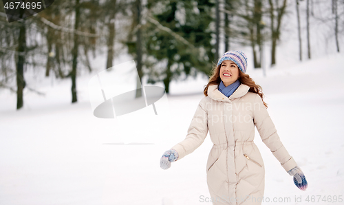 Image of happy smiling woman outdoors in winter forest