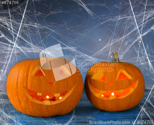 Image of two pumpkins or jack o lanterns and spiderweb