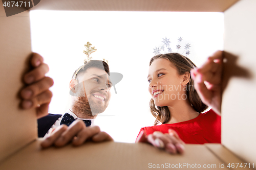 Image of happy couple opening christmas gift box