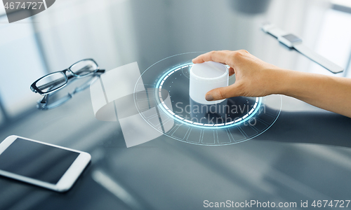 Image of hand with control knob on interactive panel