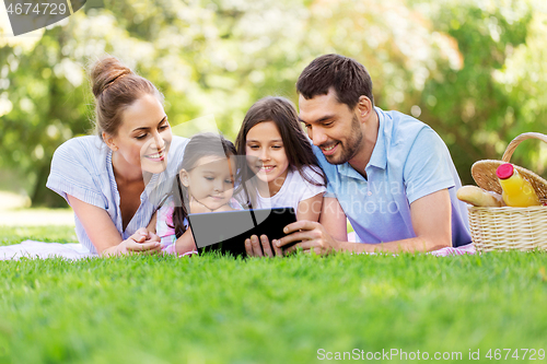 Image of family with tablet pc on picnic in summer park