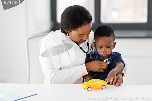 Image of doctor with stethoscope and baby patient at clinic