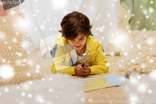 Image of boy with magnifier and map in kids tent at home