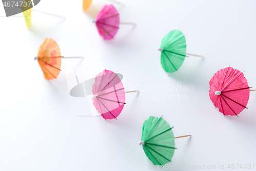 Image of cocktail umbrellas on white background