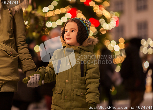 Image of happy little boy with mother at christmas market