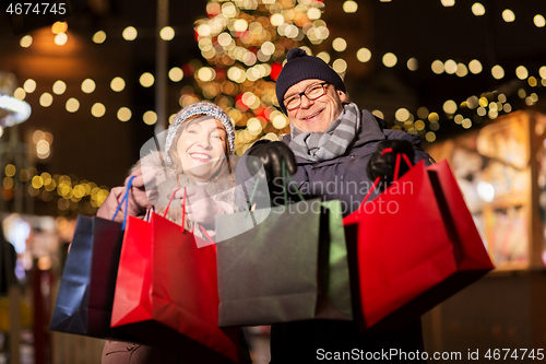 Image of old couple at christmas market with shopping bags