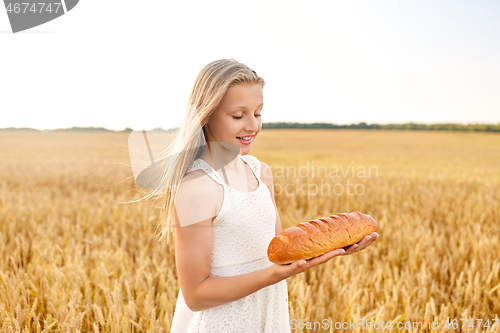 Image of girl with loaf of white bread on cereal field