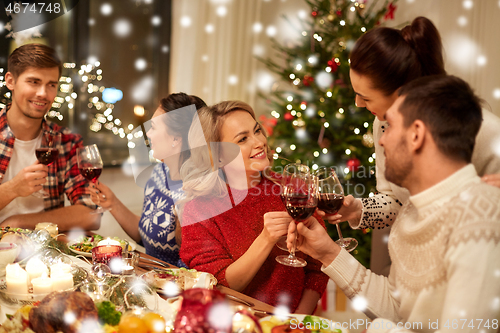 Image of friends celebrating christmas and drinking wine