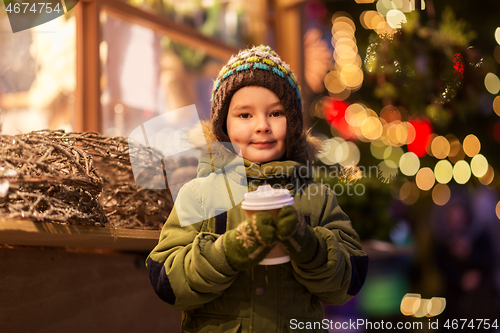 Image of happy boy with cup of tea at christmas market