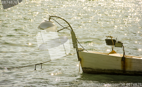 Image of Small fishing boat on sunset