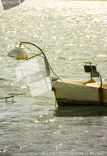 Image of Small fishing boat on sunset