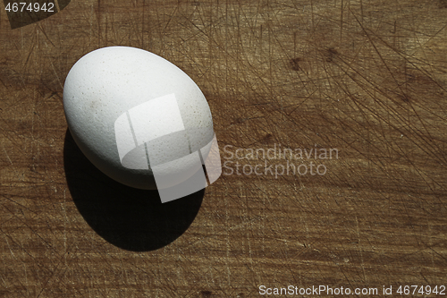 Image of Egg on wooden board