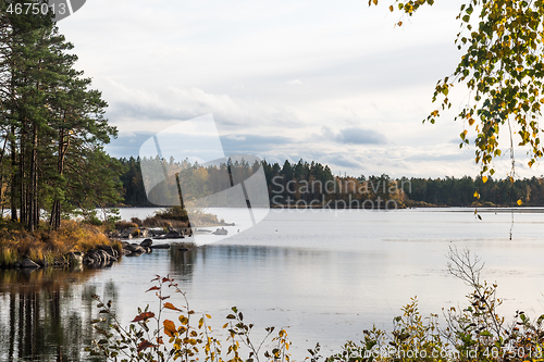 Image of Calm lake view with autumn colors