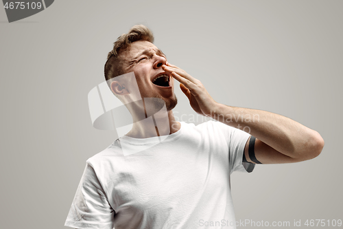 Image of Young man with beard yawning