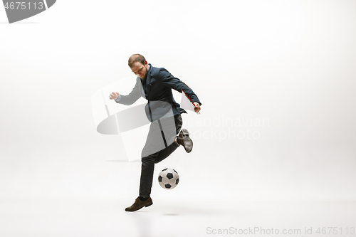 Image of Businessman with football ball in office