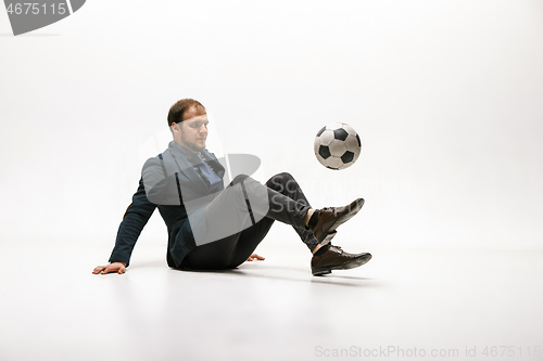 Image of Businessman with football ball in office