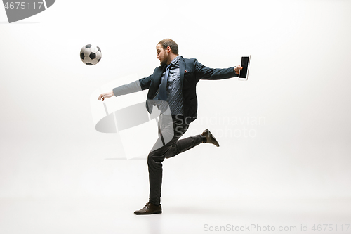 Image of Businessman with football ball in office