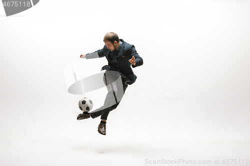 Image of Businessman with football ball in office