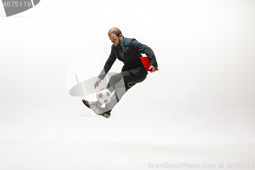 Image of Businessman with football ball in office