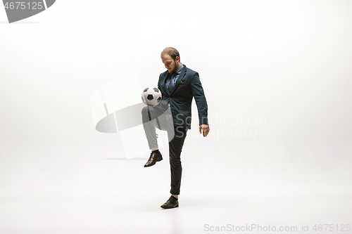 Image of Businessman with football ball in office