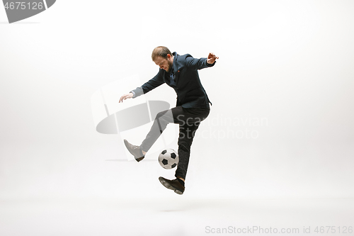 Image of Businessman with football ball in office