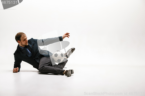 Image of Businessman with football ball in office